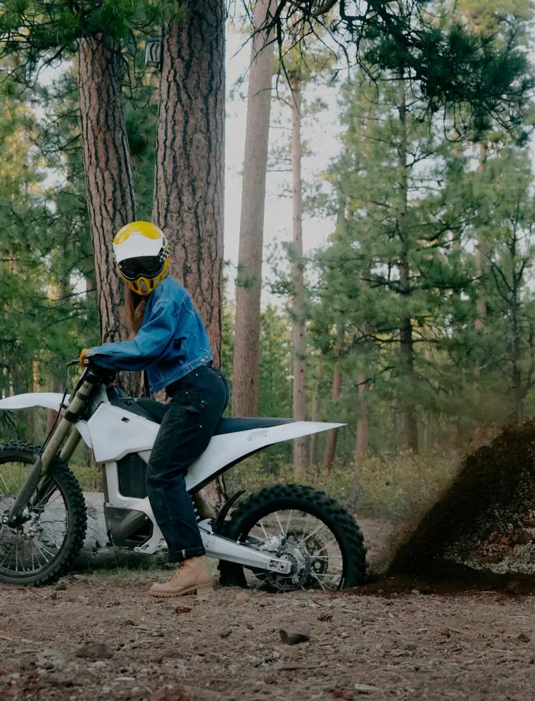Young rider on the bike on a forest trail